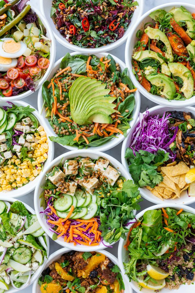 Prepared salad bowls with avocado, corn, cucumber and tofu