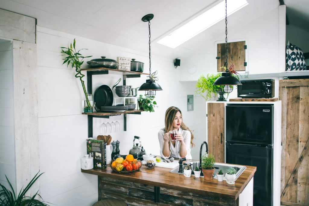 Woman enjoying a morning drink in a bright home kitchen