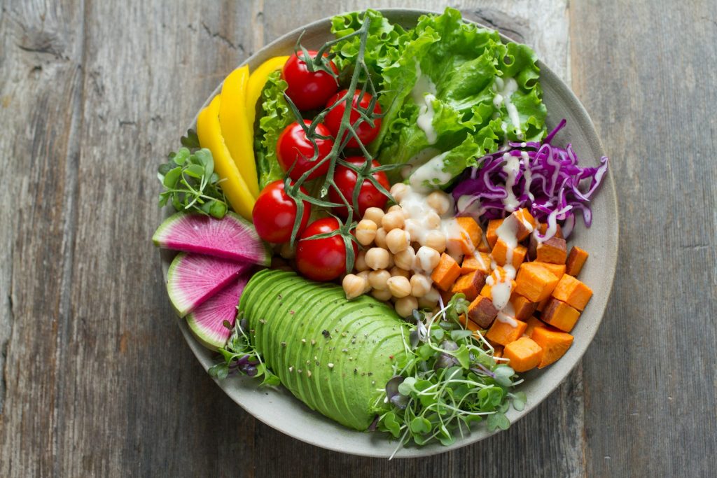 Salad bowl with chickpeas, avocado, tomatoes and cabbage