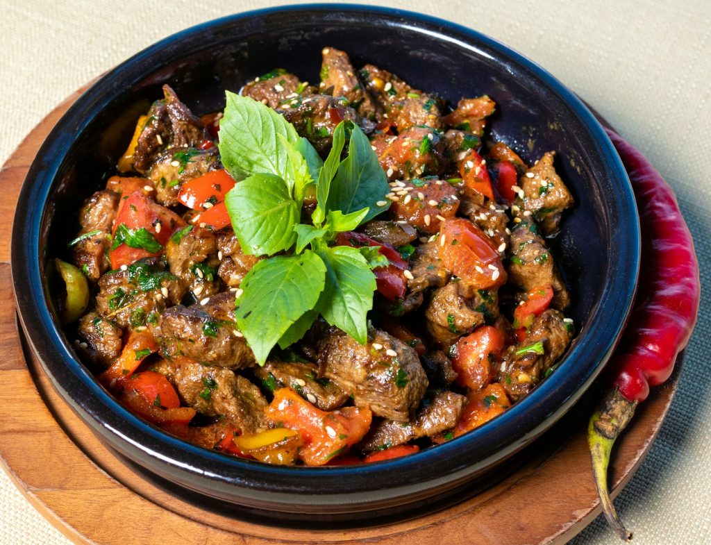 Stir-fry with vegetables and fresh herbs in a dark bowl