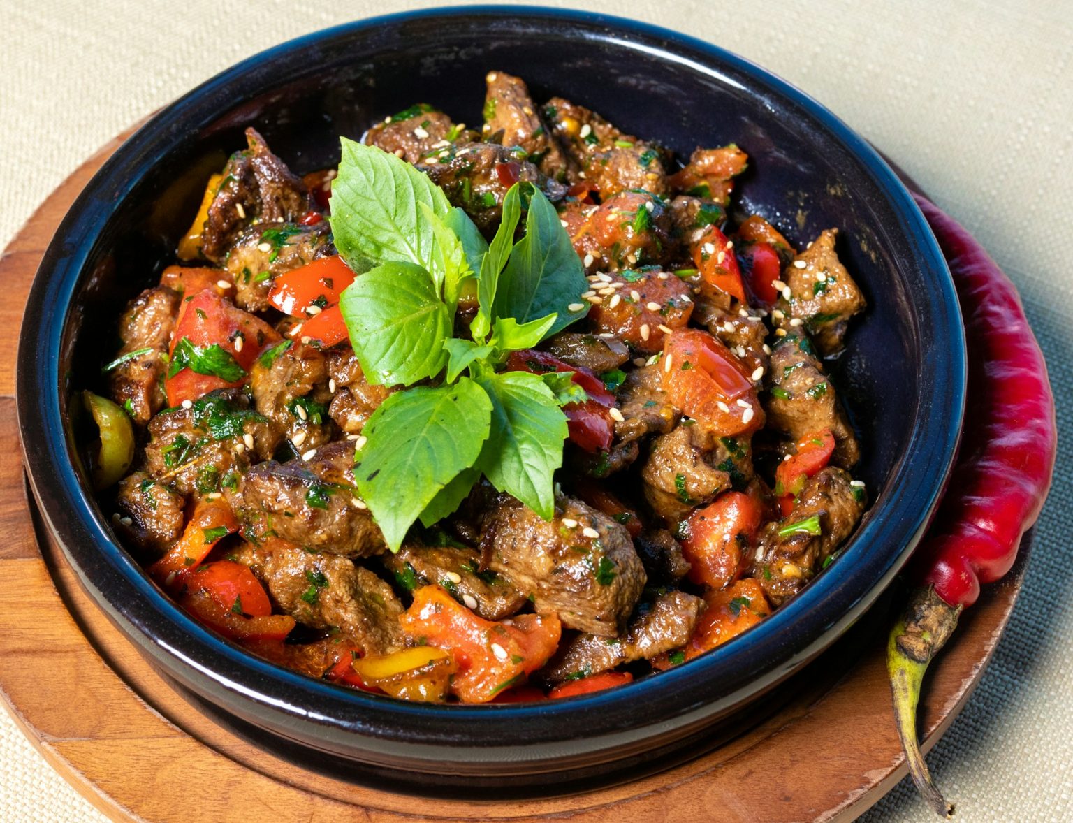 Stir-fry with vegetables and fresh herbs in a dark bowl